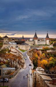 a view of a castle with a road and buildings at Апартаменти біля Фортеці in Kamianets-Podilskyi