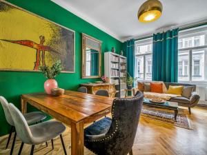 a living room with a wooden table and chairs at Timeless Prague Apartment by House of Huxe in Golčŭv Jeníkov