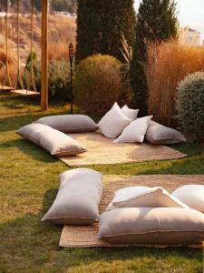 a row of pillows laying on the grass at Dali Heartland Castle VILLA Cliffside Sea View Estate in Dali