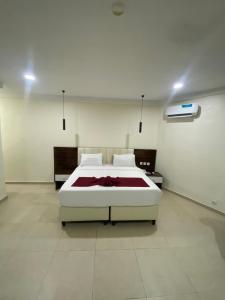 a bedroom with a large white bed in a room at Chateux de atlantique Hotel in Lagos