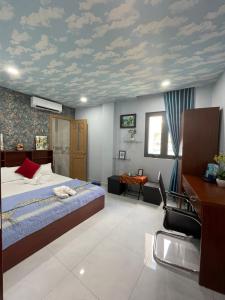 a bedroom with a bed and a desk and a ceiling at Penthouse BNB in Ho Chi Minh City