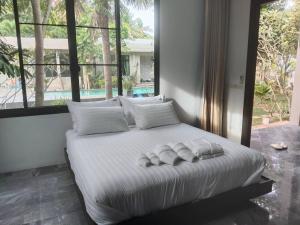 a bedroom with a bed with towels on it at Villa89 Chumphon  +43 photos