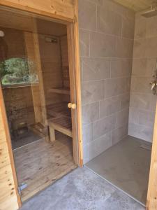 a shower with a glass door in a room at Dom Zegarmistrza in Mirosławiec