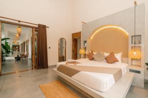 a bedroom with a large white bed in a room at Oura Spirit in Unawatuna +62 photos