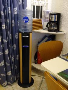 a water dispenser with a bucket on top of it at Cool Studio in Flic-en-Flac +40 photos