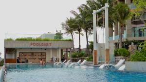 a swimming pool at a resort with a pool party at Beachfront Condotel - Free Pool Access - Apec Mandala Mui Ne in Ấp Thiẹn Ái