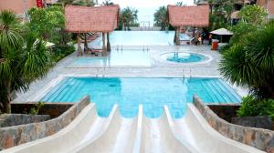 a swimming pool in a resort with a swimming poolvisorvisor at Beachfront Condotel - Free Pool Access - Apec Mandala Mui Ne in Ấp Thiẹn Ái