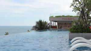 a pool at a resort with the ocean in the background at Beachfront Condotel - Free Pool Access - Apec Mandala Mui Ne in Ấp Thiẹn Ái +219 photos