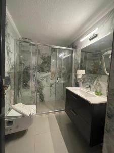 a bathroom with a shower and a sink at Belle Vue Ölüdeniz in Fethiye