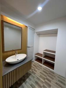 a bathroom with a sink and a mirror at Esprutingkle Business Hotel Kidapawan in Kidapawan
