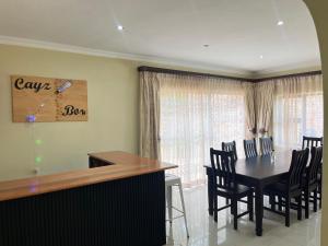 a dining room with a black table and chairs at CozyNest in Margate
