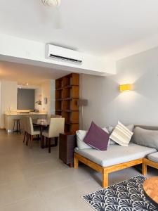 a living room with a couch and a table at La Residence with LOV in Midlands Station