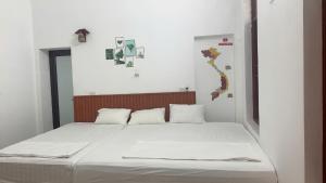 Ένα ή περισσότερα κρεβάτια σε δωμάτιο στο Bloom Homestay