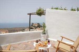 a tray of food on a table on a balcony at VILLA CALLIOPE KEA in Ioulida