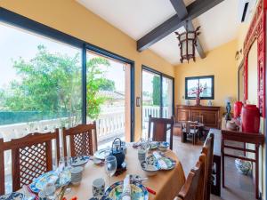 a dining room with a table and chairs and windows at Villa Jenuska, Attractive holiday home in Callian with private pool in Callian