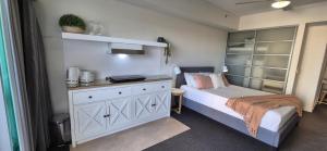 a small bedroom with a bed and a dresser at ツ Home Away From Home ツ in Darwin +6 photos