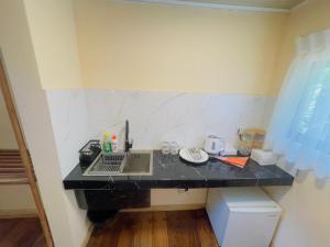 a black counter with a laptop on it in a room at Beach Cabanas Hiriketiya in Hiriketiya