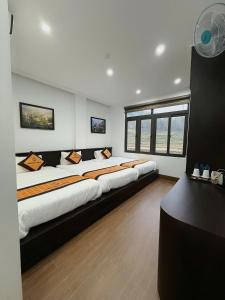 a large room with two large beds in it at Friendly Hotel in Dồng Văn