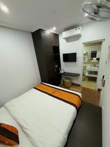 a bedroom with a bed and a living room at Friendly Hotel in Dồng Văn