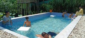 a group of people in a swimming pool at Sikhri Kaziranga Homestay in Kāziranga