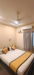 a bedroom with a large bed with two pillows at bangalore residency in Srikalahasti