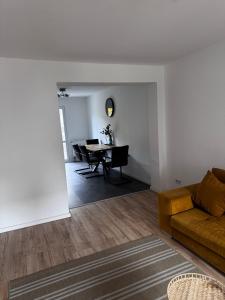 a living room with a couch and a table at Stadtwohnung im Luisenviertel in Wuppertal +9 photos