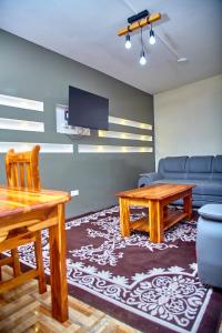 a living room with a couch and a table and a tv at Appartement meublé AKAPEO in Lomé