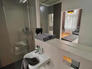 a bathroom with a sink and a mirror at Wroclaw City Apartments in Wrocław +62 photos