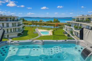 a swimming pool on the balcony of a building at SzemesBay Apartment by BLTN in Balatonszemes