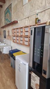 a kitchen with a refrigerator and a microwave at Hostel Menorca in Ciutadella