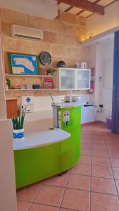 a kitchen with a green counter in a room at Hostel Menorca in Ciutadella +41 photos