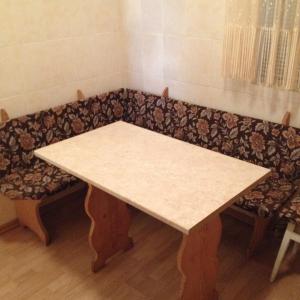 a wooden table with a bench in a room at Apartment Downtown in Mukacheve