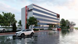 een witte auto geparkeerd op een parkeerplaats voor een gebouw bij Papagei Cosy Home in Staßfurt