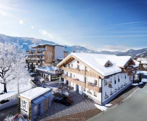 eine Luftansicht eines Gebäudes mit Schnee darauf in der Unterkunft PACHMAIR 1453 apart resort in Uderns + 80 Fotos