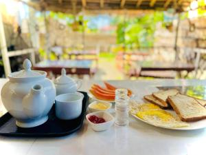 a table with a breakfast of eggs bread and toast at AP Pearl Palace -Tangalle in Tangalle