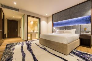 a bedroom with a large bed and a large wall at Hotel Lumbini Heritage in Lumbini +20 photos