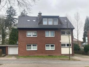 a red brick house with a black roof at Gemütliche Dachgeschoss Wohnung in Selm