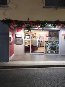 a store front with christmas wreaths on the windows at Hotel De La Bastide in Carcassonne