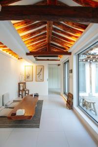 a living room with a wooden table and large windows at 무료주차 스파 청량리 가족 독채 한옥 in Seoul