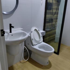 a bathroom with a toilet and a sink and a shower at Baanjaifu บ้านใจฟู in Mukdahan +14 photos