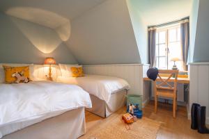 En eller flere senge i et værelse på Ferienwohnung Gut Immenhof