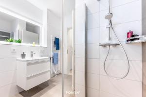 a white bathroom with a shower and a sink at Penthouse Kapitänskajüte, App 25 Olpenitz in Olpenitz