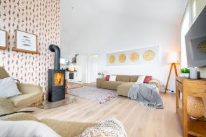 a living room with a wood stove in it at Penthouse Kapitänskajüte, App 25 Olpenitz in Olpenitz +15 photos
