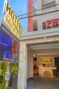 a hotel building with a hotel sign in front of it at Phương Anh Hotel Dĩ An in Dĩ An +19 photos