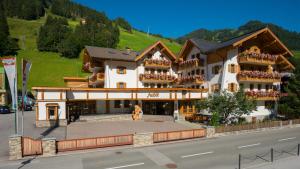 a large building on the side of a street at Hotel Auhof in Grossarl