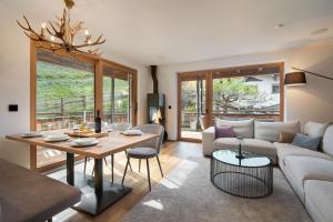 a living room with a couch and a table at Chalet Florian in Kirchberg in Tirol