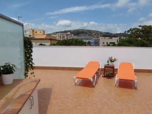 two orange chairs sitting on top of a roof at Apartment Sun & Beach in Platja d'Aro in Platja d'Aro