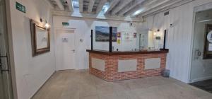 a room with a brick fireplace in a building at Hotel Rural Atalaya in Guadalupe