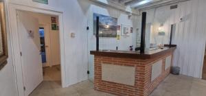 a room with a brick fireplace with a mirror at Hotel Rural Atalaya in Guadalupe