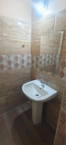 a bathroom with a white sink and a mirror at bangalore residency in Srikalahasti +34 photos